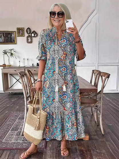 Robe tunique longue style bohème à imprimé cachemire et col noué avec pompons - Style vacances élégant avec cordon de serrage, ourlet à volants et imprimé aléatoire 