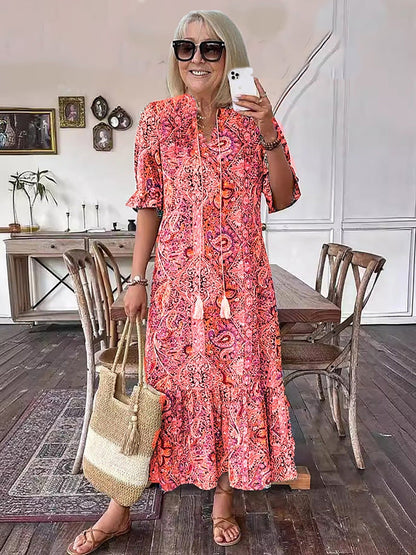 Robe tunique longue style bohème à imprimé cachemire et col noué avec pompons - Style vacances élégant avec cordon de serrage, ourlet à volants et imprimé aléatoire 