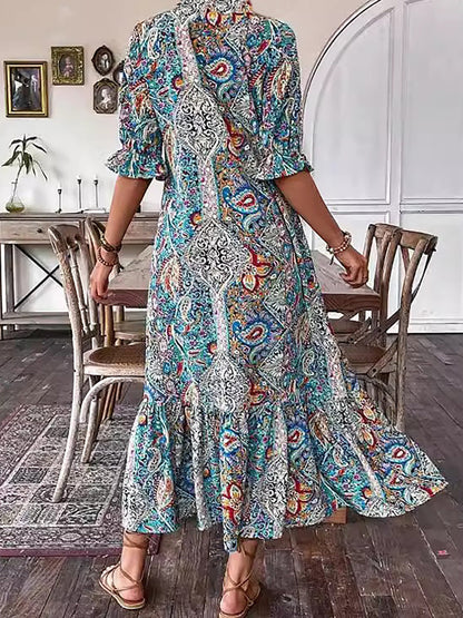 Robe tunique longue style bohème à imprimé cachemire et col noué avec pompons - Style vacances élégant avec cordon de serrage, ourlet à volants et imprimé aléatoire 