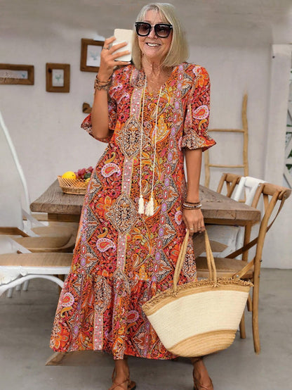Robe tunique longue style bohème à imprimé cachemire et col noué avec pompons - Style vacances élégant avec cordon de serrage, ourlet à volants et imprimé aléatoire 